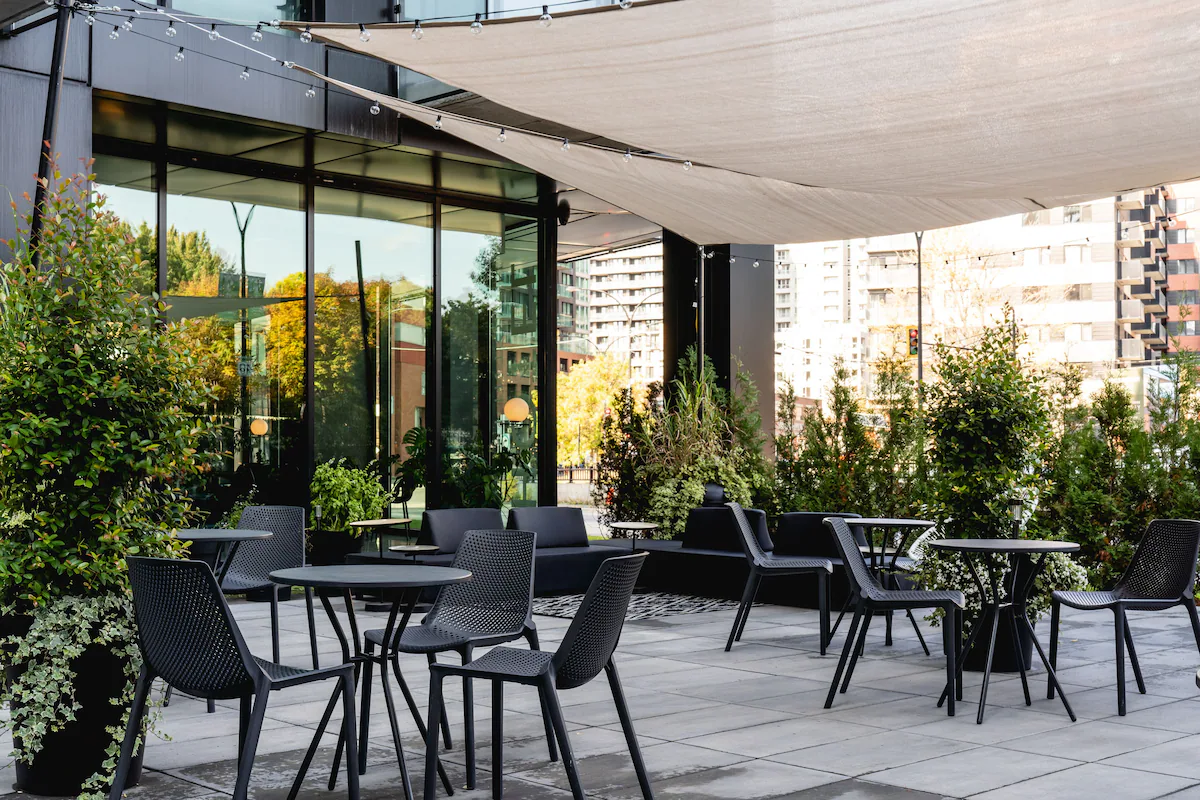 Griffintown Hotel garden terrace with seating under a shade canopy
